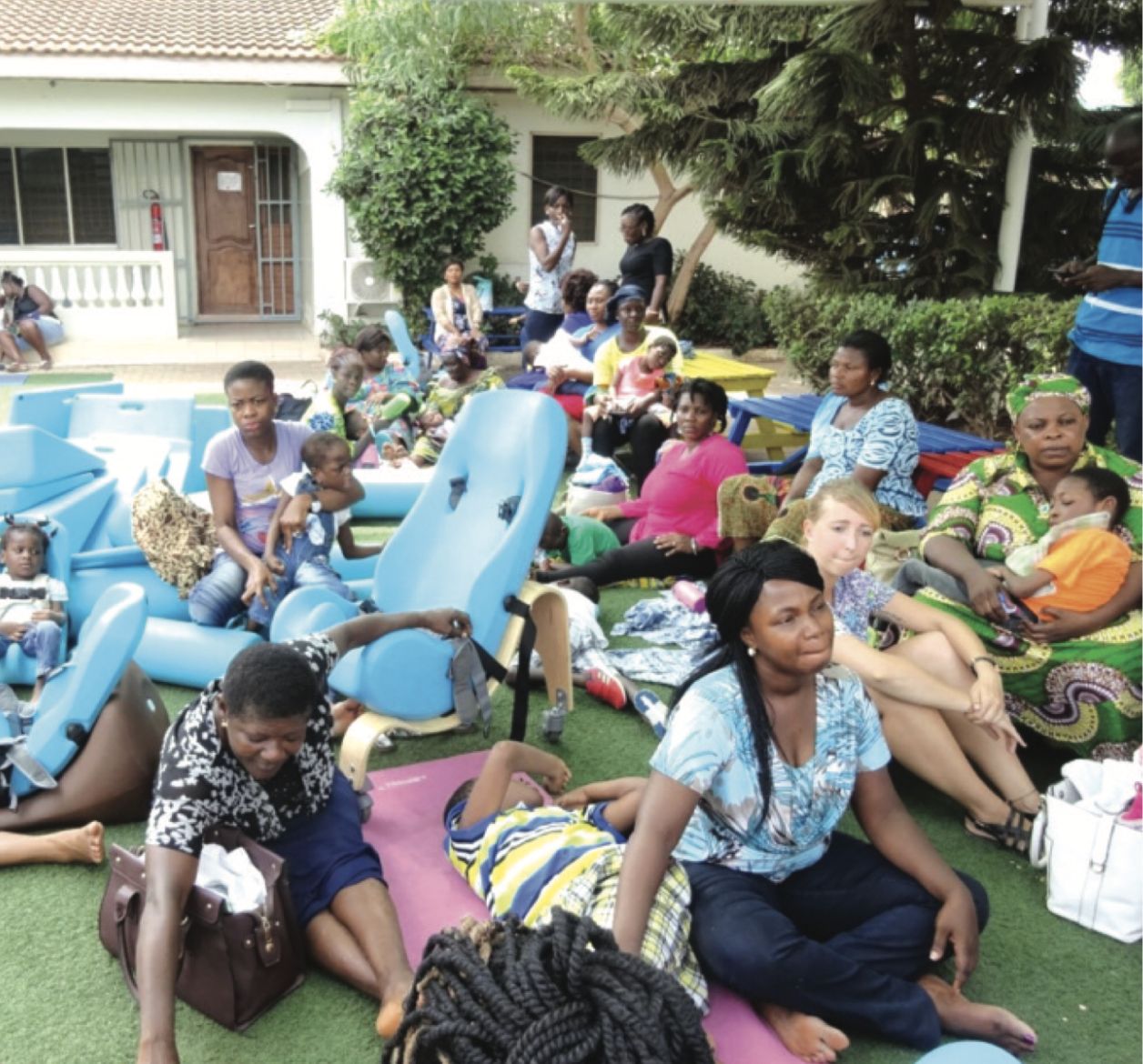 Group of healthcare workers and parents with medical aids and equipment all being used by children